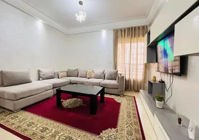 a living room with a couch and a table at Familly Residence in Casablanca