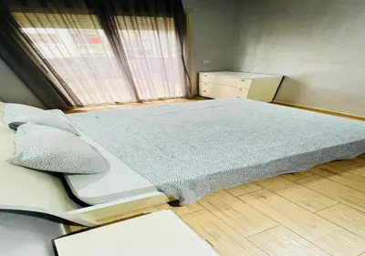 a bedroom with a large bed and a window at Familly Residence in Casablanca