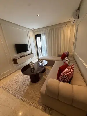 a living room with a couch and a table at Suite Apartment Maarif Val Fleurie à louer in Casablanca