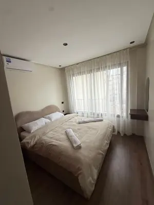 a large bed in a bedroom with a window at Suite Apartment Maarif Val Fleurie à louer in Casablanca