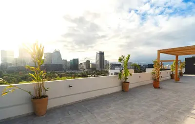 a balcony with potted plants and a view of a city at Appartement moderne avec parking, toit terrasse et salle de sport - Anfa Park in Casablanca
