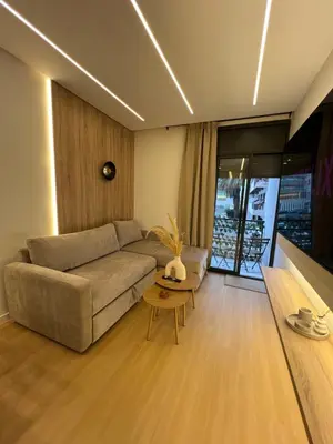 a living room with a couch and a table at Central T1 cozy and chic in Rabat