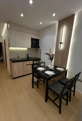 a kitchen and dining room with a table and chairs at Central T1 cozy and chic in Rabat