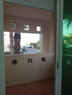 a door with a palm tree outside of it at Oceania in Mohammedia