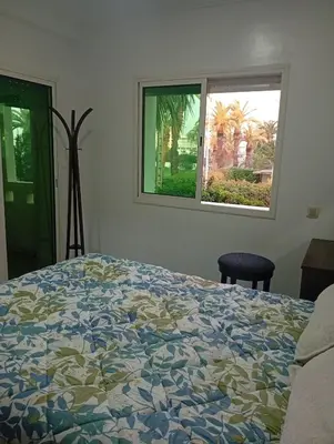a bedroom with a bed and a window at Oceania in Mohammedia