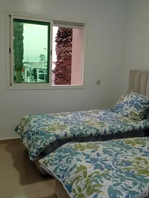 two beds in a room with a window at Oceania in Mohammedia