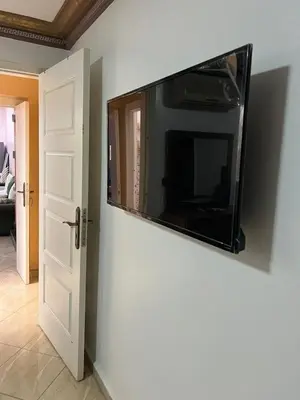 a flat screen tv hanging on a wall at Cozy Apartment Rabat in Rabat