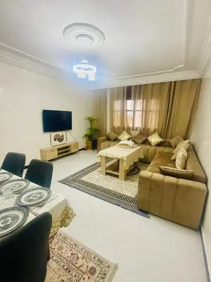 a living room with a couch and a table at Nouvel appartement dans le quartier central très agréable à proximité de tous les services in Temara