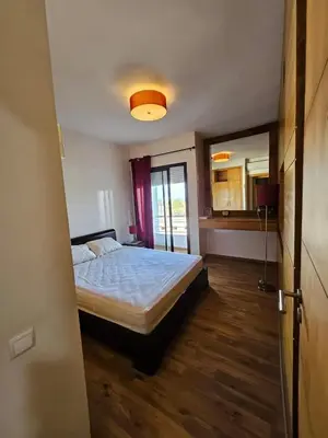 a bedroom with a bed and a large mirror at Appartement lumineux avec parking privé in Temara