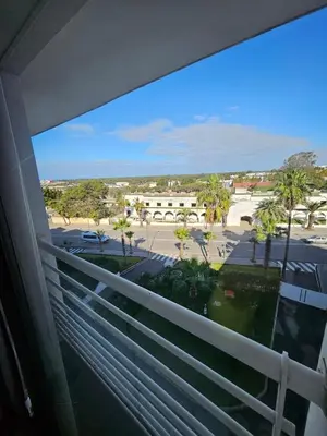 a balcony with a view of a parking lot at Appartement lumineux avec parking privé in Temara