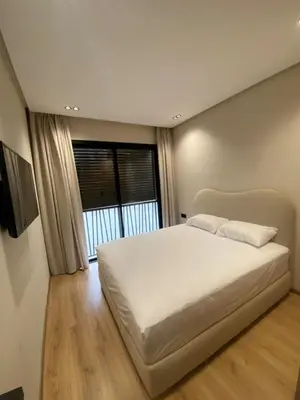a bedroom with a large white bed and a window at CFC centre d'affaires - Salle de sport - Wifi in Casablanca