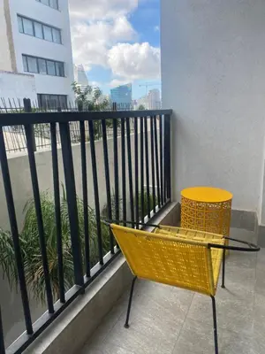 a yellow chair sitting on a balcony with a window at CFC centre d'affaires - Salle de sport - Wifi in Casablanca