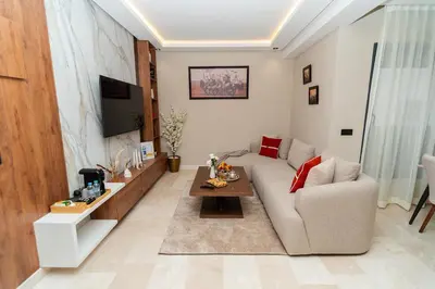 a living room with a couch and a table at Elegant Studio at 2 Mars Modern, Quiet Convenient in Casablanca