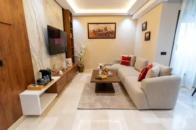 a living room with a couch and a table at Elegant Studio at 2 Mars Modern, Quiet Convenient in Casablanca
