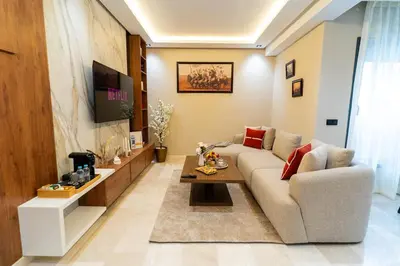 a living room with a couch and a table at Elegant Studio at 2 Mars Modern, Quiet Convenient in Casablanca