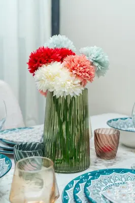 a green vase with red and white flowers on a table at Elegant Studio at 2 Mars Modern, Quiet Convenient in Casablanca
