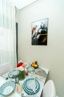 a dining room table with blue and white plates on it at Elegant Studio at 2 Mars Modern, Quiet Convenient in Casablanca