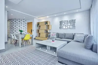 a living room with a couch and a table at Chic 3BR in Racine by Bd Massira in Casablanca