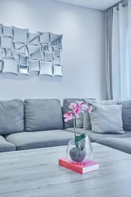 a living room with a couch and a vase with flowers at Chic 3BR in Racine by Bd Massira in Casablanca