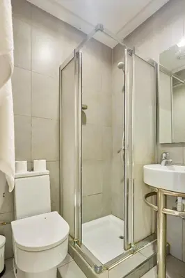 a bathroom with a shower and a toilet and a sink at Chic 3BR in Racine by Bd Massira in Casablanca