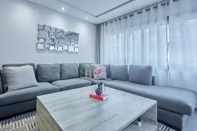 a living room with a couch and a table at Chic 3BR in Racine by Bd Massira in Casablanca