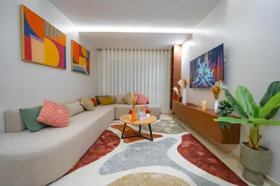 a living room with a couch and a table at Soleya Apartment with Pool near Mohammed V Airport in Nouaseur
