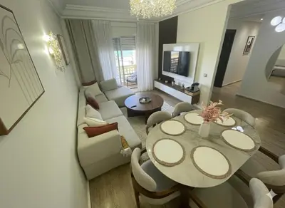 a living room with a table and chairs and a couch at Appartement vue sur mer - Chill ocean view in Rabat