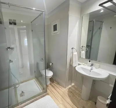 a bathroom with a shower and a sink and a toilet at Appartement vue sur mer - Chill ocean view in Rabat
