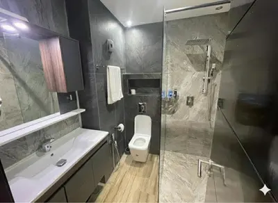 a bathroom with a toilet and a sink and a shower at Appartement vue sur mer - Chill ocean view in Rabat