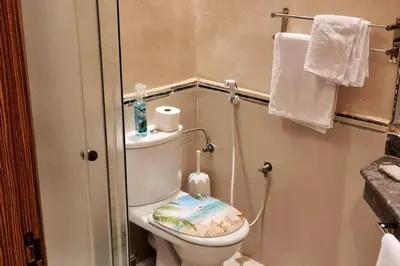 a bathroom with a toilet with a book on the seat at Casablanca !Tamaris! 2 bedrooms! Pool & Sea View! in Dar Sidi Slimane