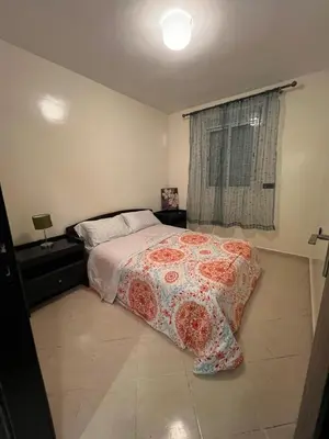 a bedroom with a bed with a red and white blanket at 2 Bedrooms 3 beds and a living room in Dar Bouazza in Dar Ben Abdallah Ben Dehbi