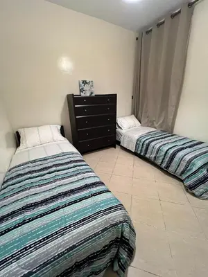 two beds sitting next to each other in a bedroom at 2 Bedrooms 3 beds and a living room in Dar Bouazza in Dar Ben Abdallah Ben Dehbi