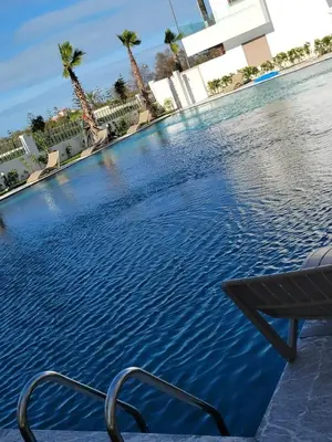 a pool at a hotel with a chair in it at heaven beach in Sidi Rahal