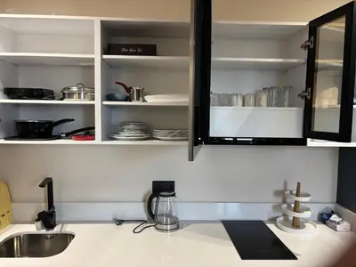 a kitchen counter with a sink and a cabinet with dishes at Bridge Collection - Argana in Casablanca