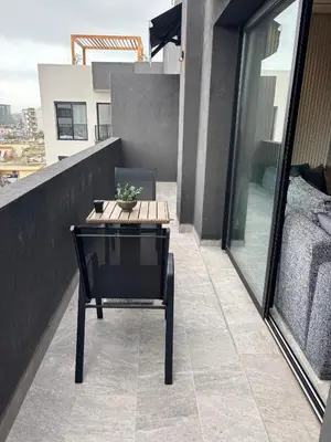 a table and a chair on a balcony at Bridge Collection - Argana in Casablanca