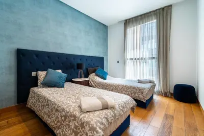 a hotel room with two beds and a window at Luxury Apartment Anfaplace Cosy & Design in Casablanca