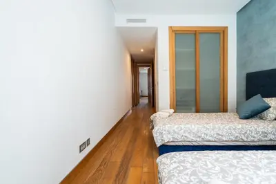 two beds in a room with wooden floors at Luxury Apartment Anfaplace Cosy & Design in Casablanca