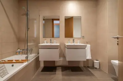 a bathroom with two sinks and a tub and a shower at Luxury Apartment Anfaplace Cosy & Design in Casablanca