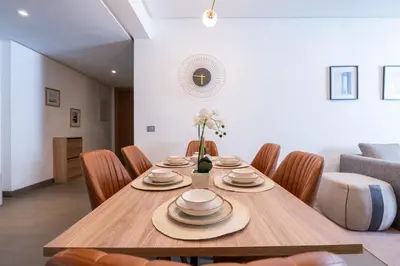 a dining room with a wooden table and chairs at Luxury Apartment Anfaplace Cosy & Design in Casablanca