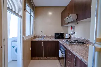 a kitchen with a sink and a counter top at Appartement luxueux &chaleureux au cœur de Rabat in Rabat