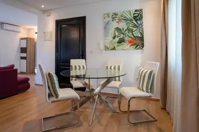 a dining room with a glass table and chairs at Appartement luxueux &chaleureux au cœur de Rabat in Rabat