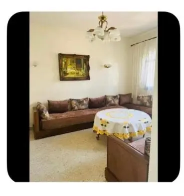 a living room with a couch and a table at Dar Khnata in Temara