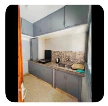 a small kitchen with a sink and a counter at Dar Khnata in Temara