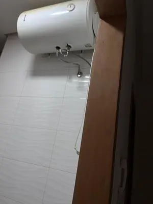 a bathroom with a white sink and a white tile floor at Havre de paix in Rabat