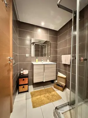 a bathroom with a sink and a shower at Appartement Moderne 2 Chambres - Piscine & Parking in Rabat