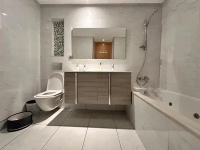 a bathroom with a sink and a toilet and a tub at Appartement Moderne 2 Chambres - Piscine & Parking in Rabat