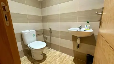 a bathroom with a toilet and a sink at 2BR Sea View Apartment - Balcony I Parking in Rabat