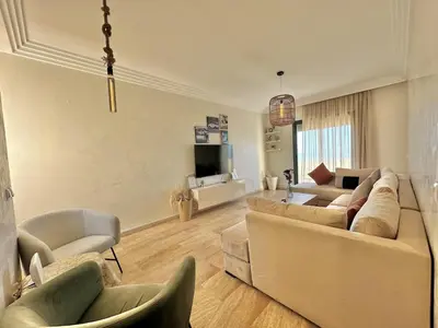 a living room with two couches and a tv at 2BR Sea View Apartment - Balcony I Parking in Rabat