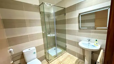 a bathroom with a shower and a toilet and a sink at 2BR Sea View Apartment - Balcony I Parking in Rabat
