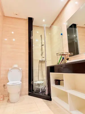 a bathroom with a shower and a toilet and a sink at Prestigia Golf City Bouskoura in Bouskoura